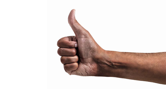 the hand of a man giving a thumbs up