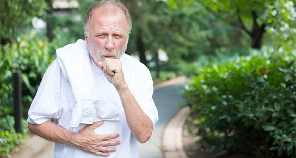 a coughing man in white running outside